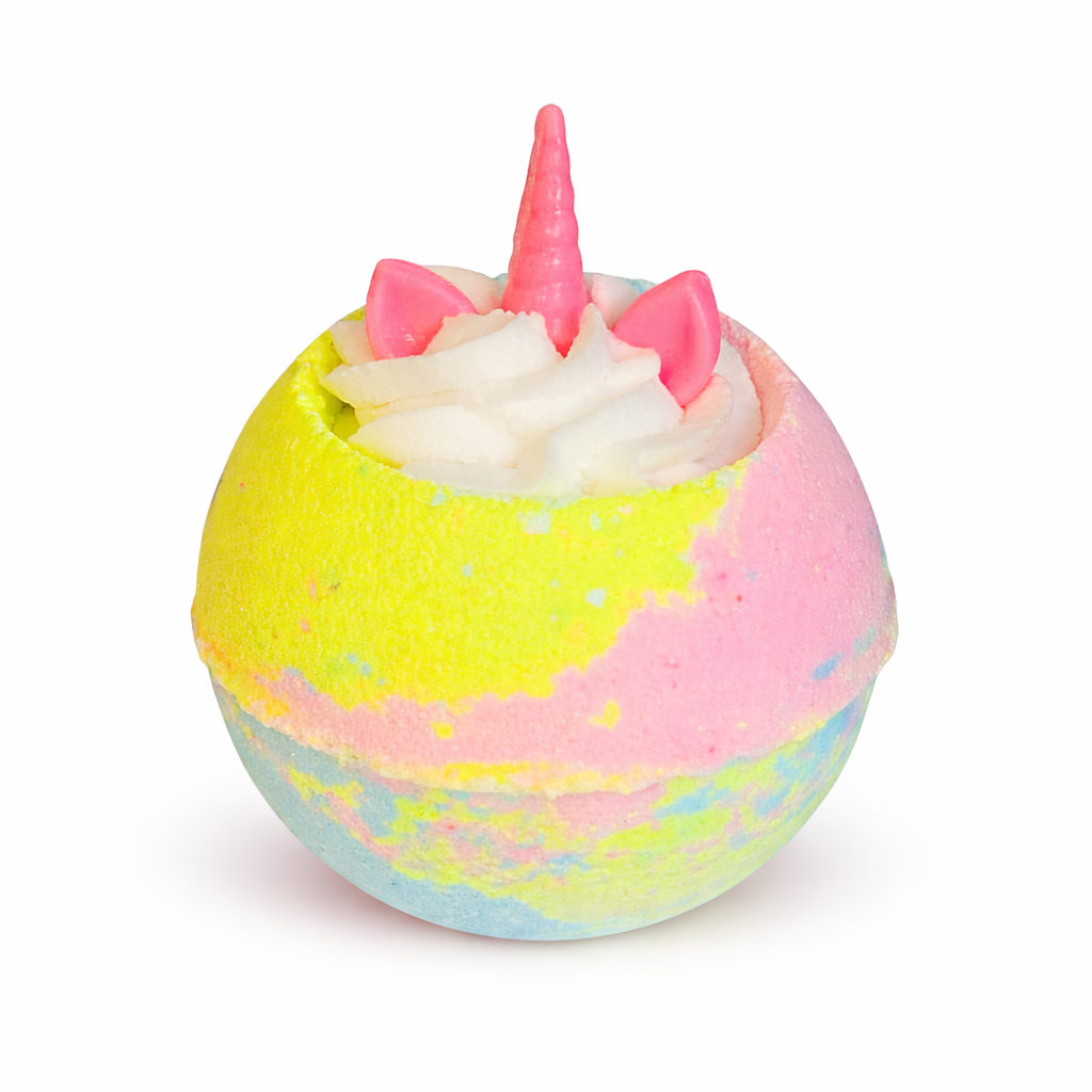 A pastel multicoloured bath bomb with white whipped bubble bath frosting on top, with unicorn ears and a horn shaped soap on top, on a white background.