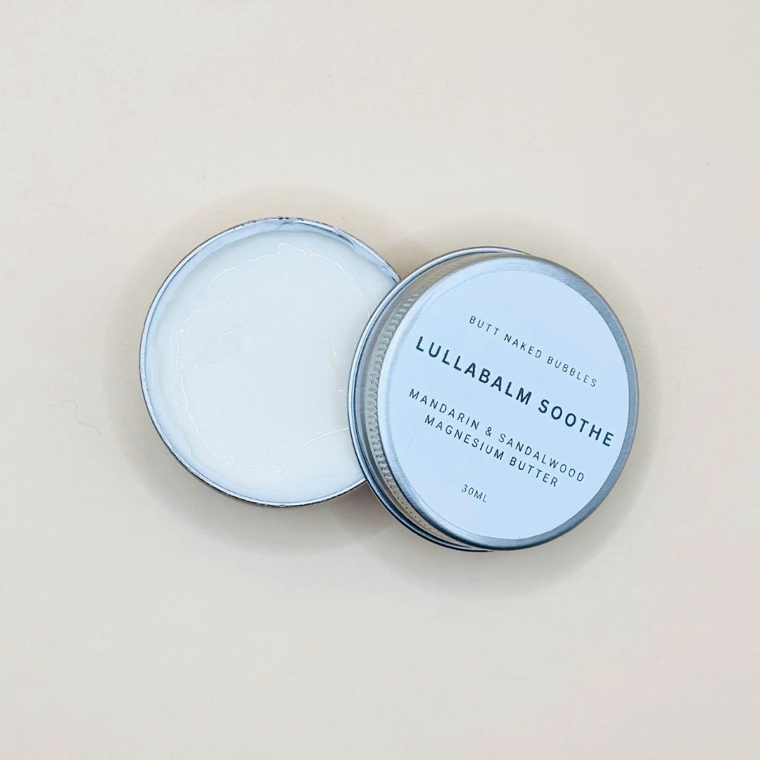 Lullabalm Soothe container with lid on a beige background