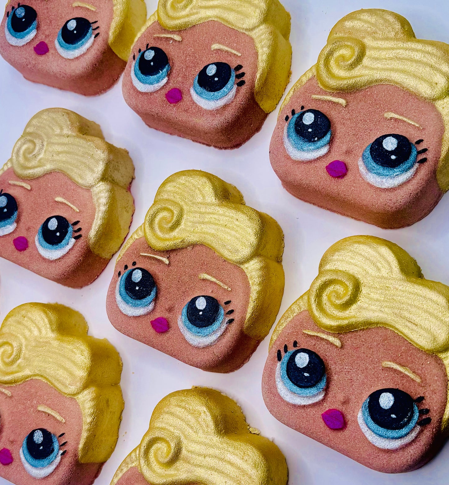a LOL Doll shaped bath bomb named Luxe. She has blonde hair and bright blue eyes.