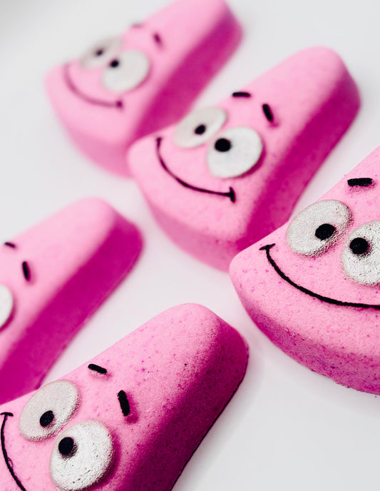 A pink triangle shaped bath bomb with patricks face on it from spongebob squarepants.